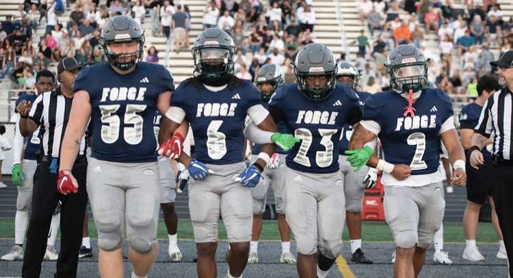 Senior captains Jake Mangano, Caleb Cleveland, Michael Johnson, and Josiah Bryson walking up to do the coin toss before the game.